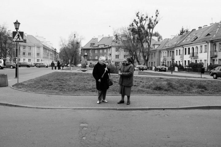 Two women talking  on the street.