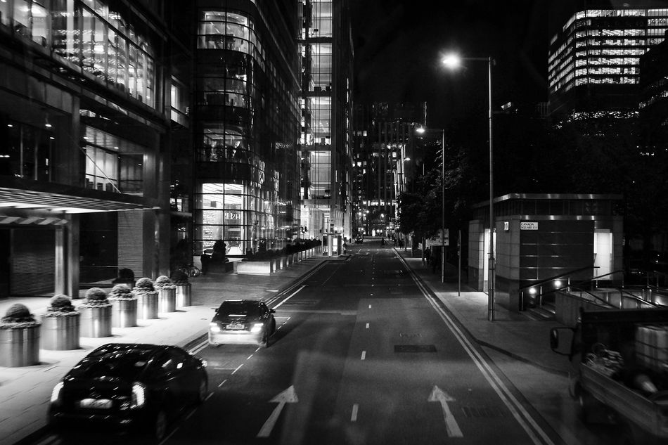 London Streets: Canary Wharf at night seen from the upper deck of the doubledecker...